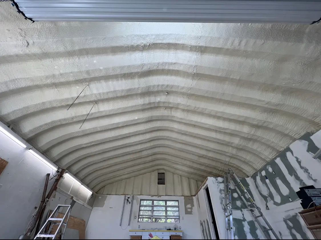 Spray polyurethane foam applied to the underside of a metal roof deck in Olivette